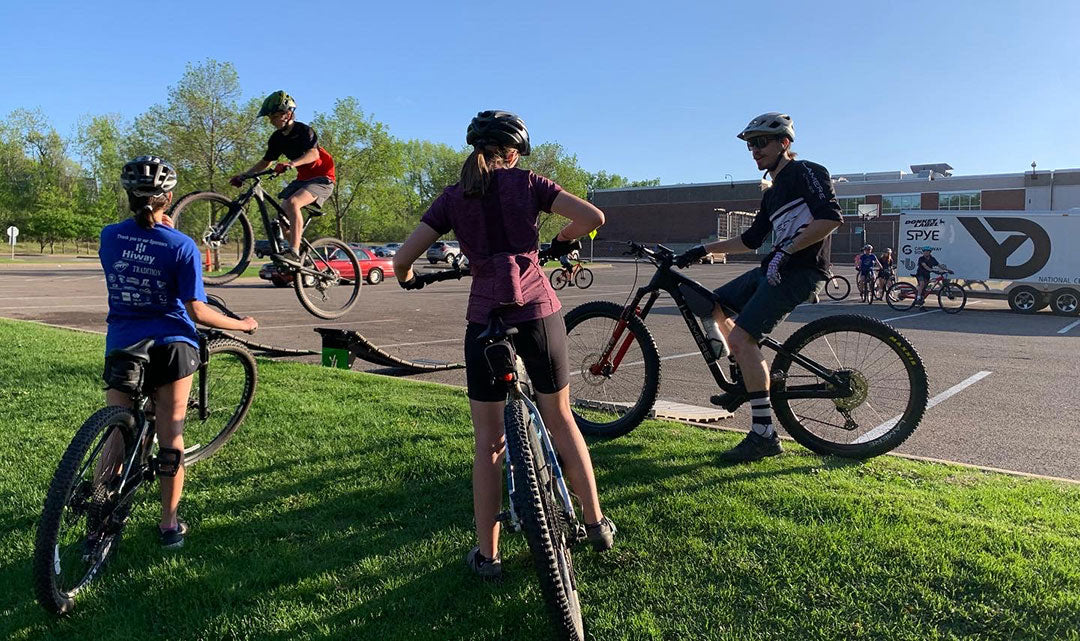 group of people riding mountain bikes on ramps