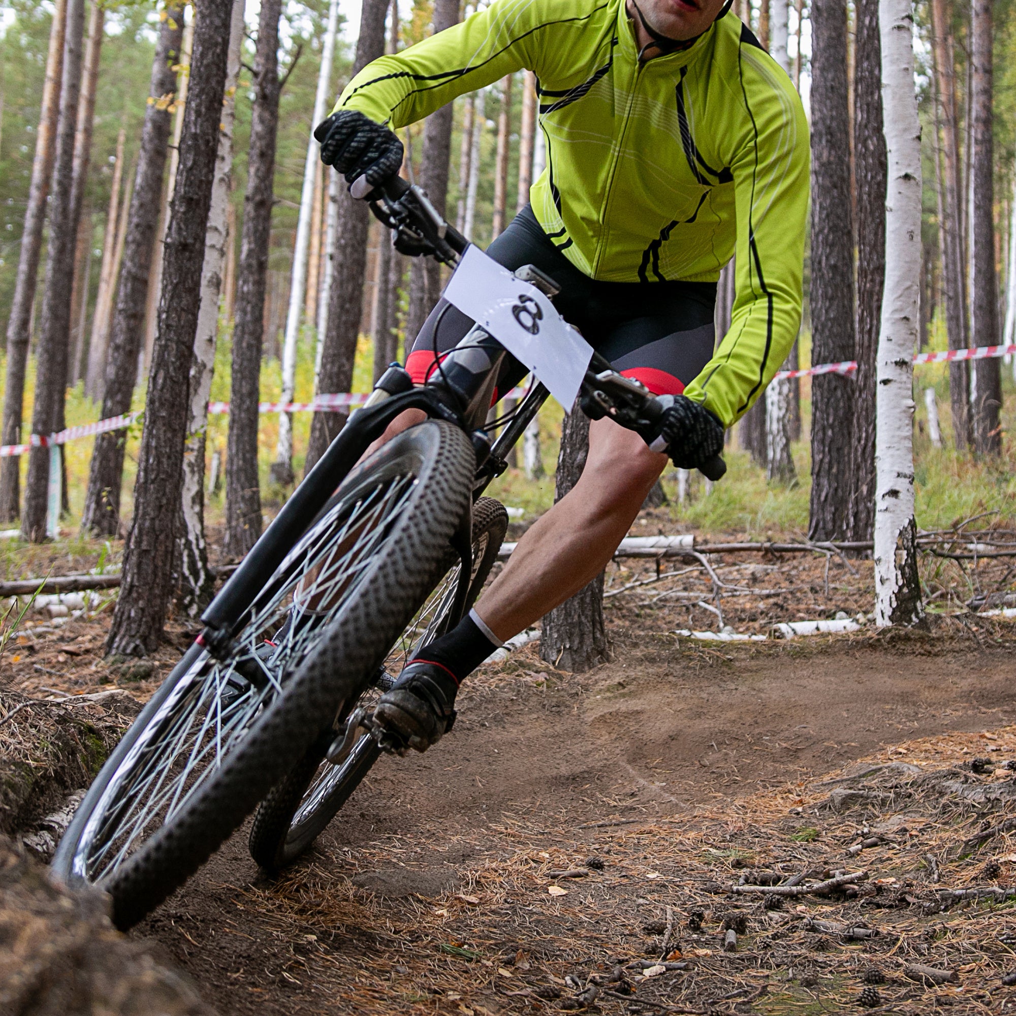Person riding a mountain bike on a trail in a forest