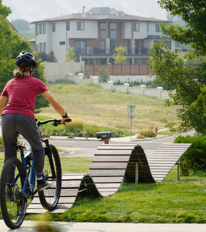 Girl rides Fezzari 29er MTB over a skills course